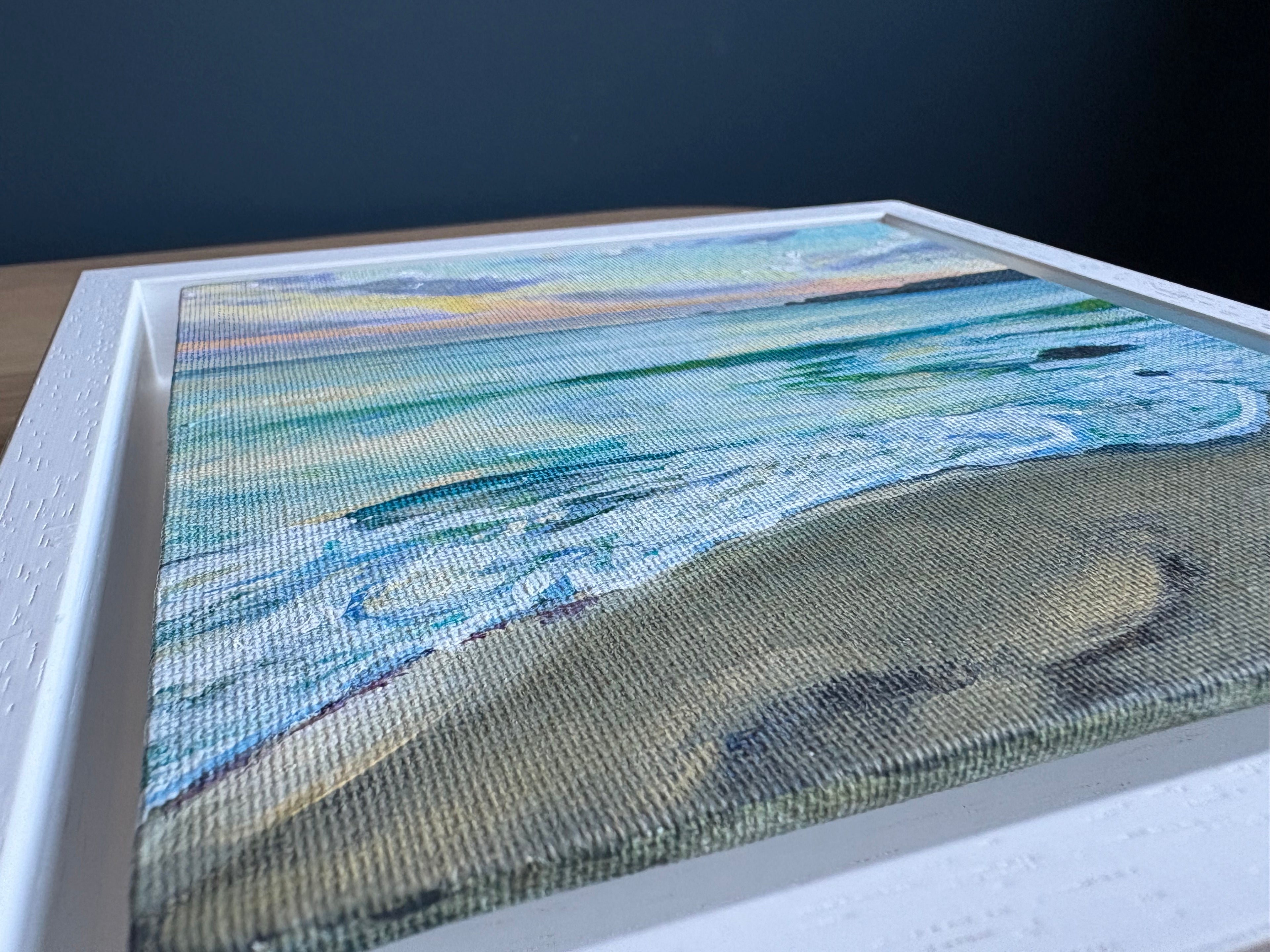 Original painting by Angela Sunley displayed on a wooden table, showcasing textures and colors for art lovers